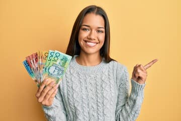 Girl smiling holding moneys
